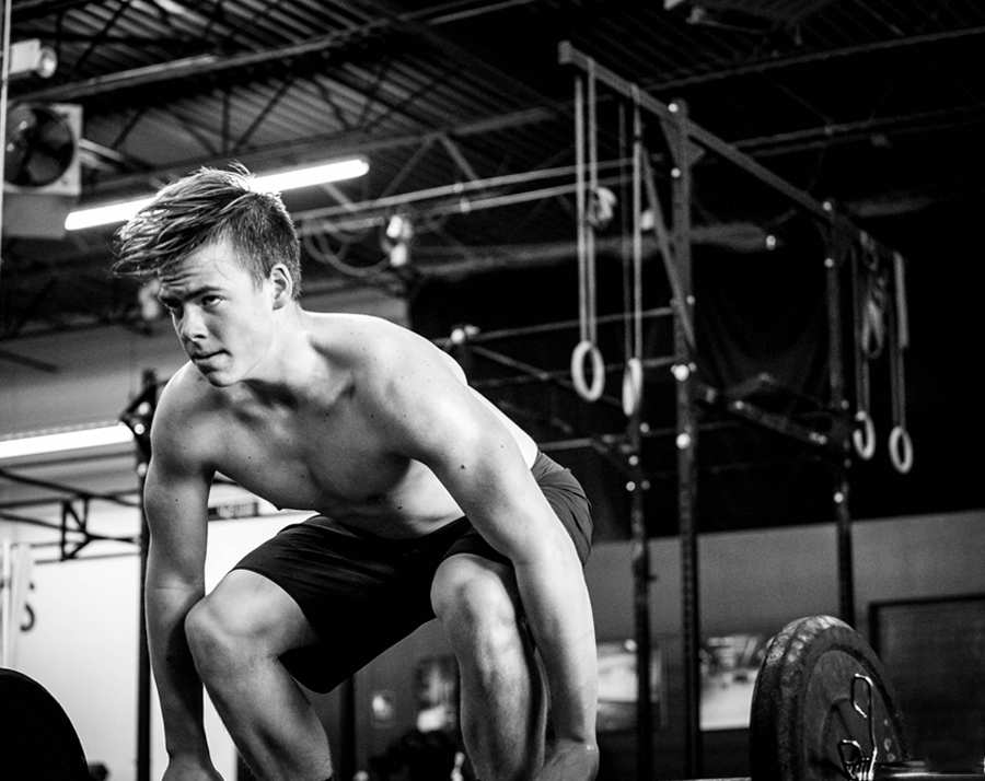 male athlete gripping barbell