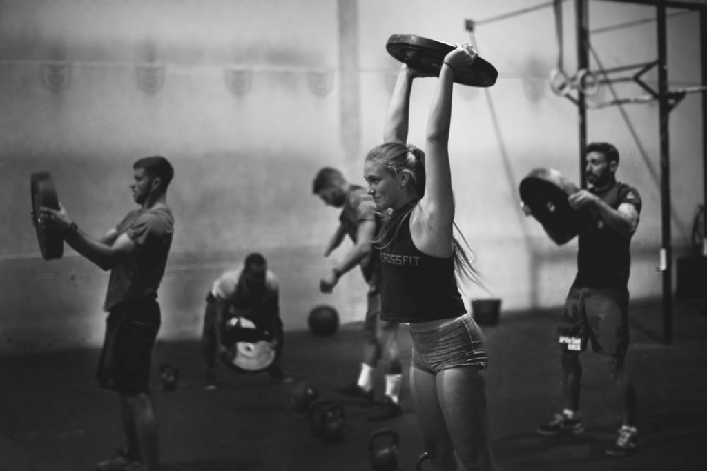 CrossFit athletes lifting weight plates