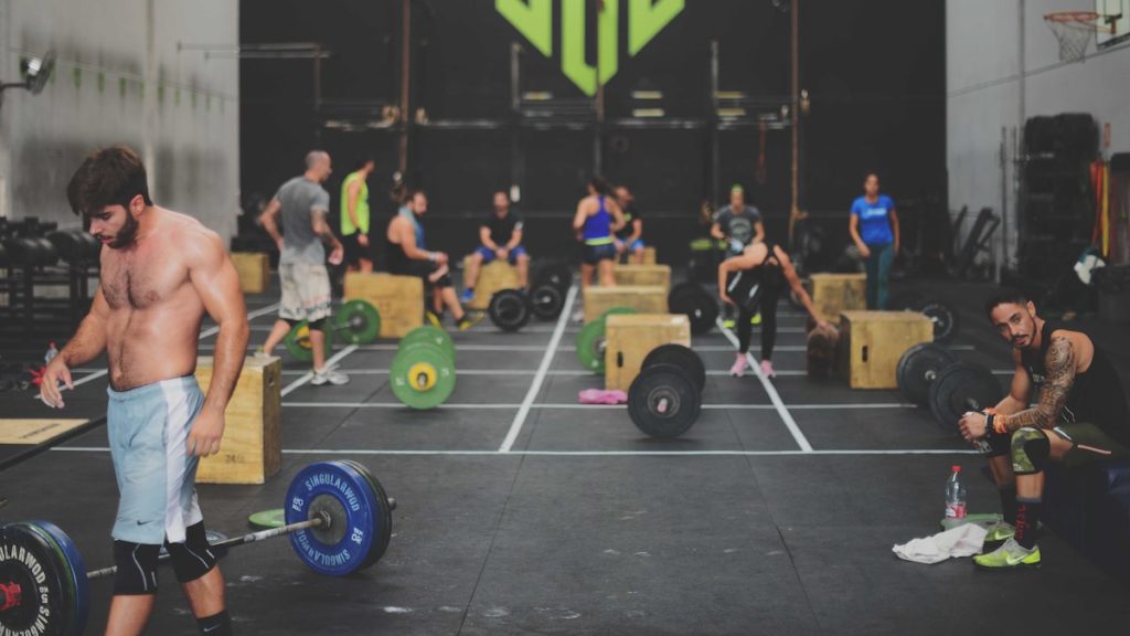 CrossFit gym full of athletes weightlifting