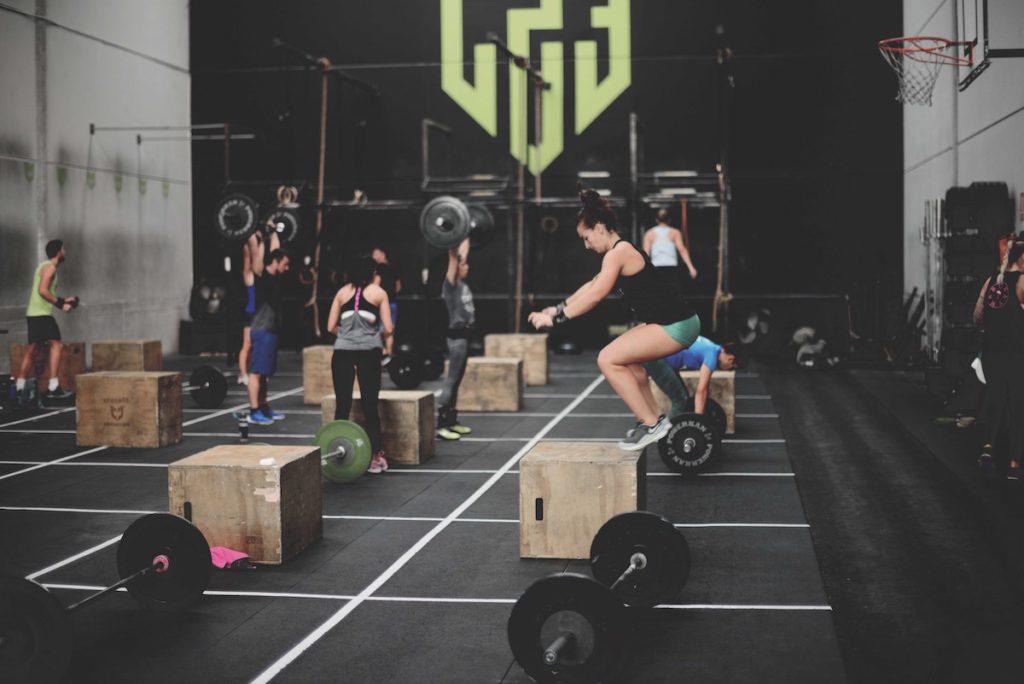 Woman performing a box jump in a gym