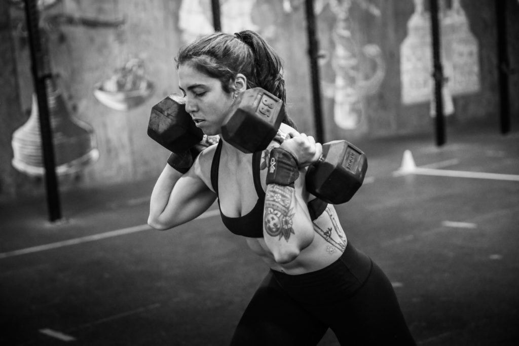 Women lifting two barbells