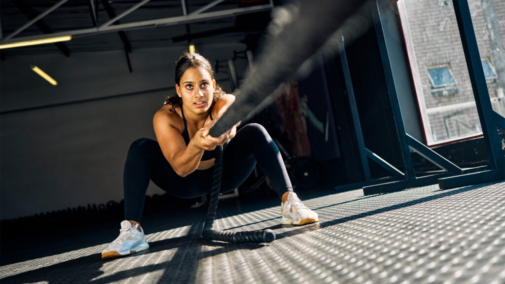 An athlete trying to practice the sled pull for the HYROX race.
