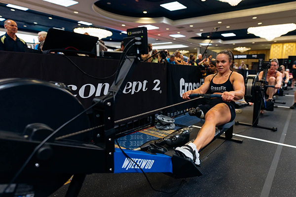 An athlete working out on a rowing machine during her CrossFit training.