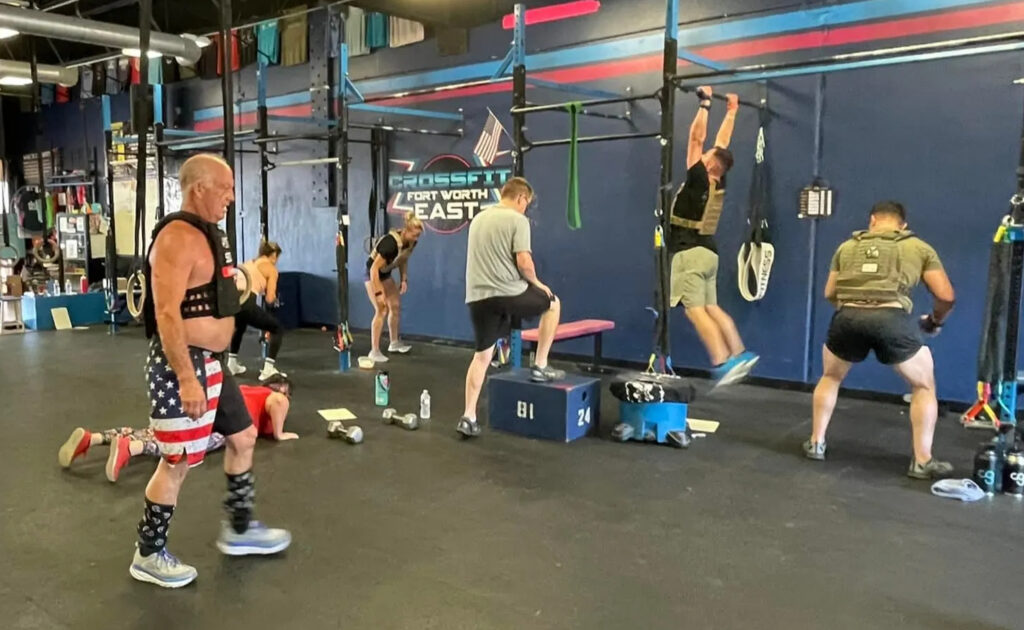 Steve Swanson, the owner of CrossFit Fort Worth East working out with the gym members.